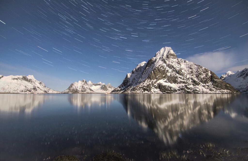 snow covered mountain range with northern lights