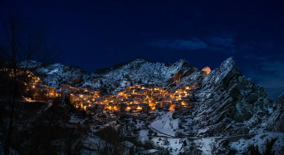 Italian city lights at night tucked into mountains