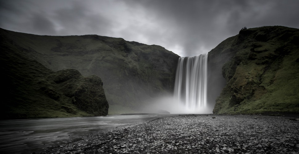 waterfall, green mountains and grey clouds