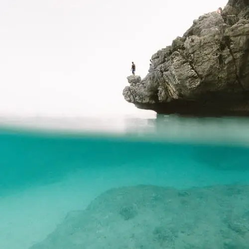 person standing on the edge of a cliff