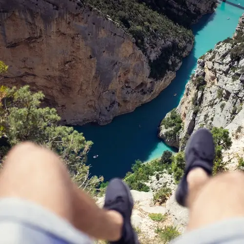 two feet dangling off edge of cliff