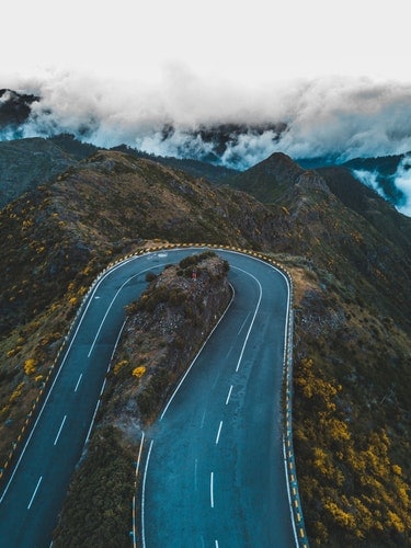 U-shaped mountain road with clouds