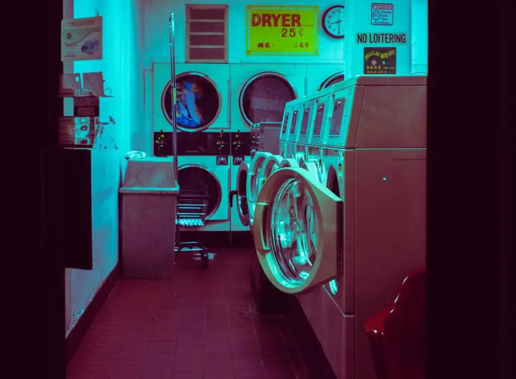 row of old-fashioned washing machines and dryers