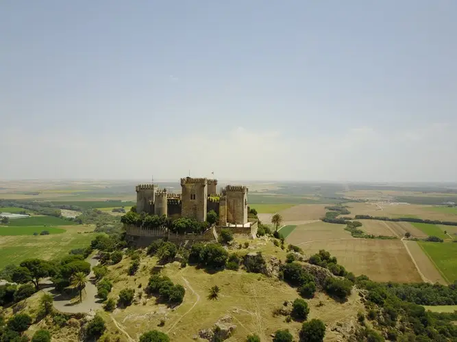 stone castle on a green rolling hill