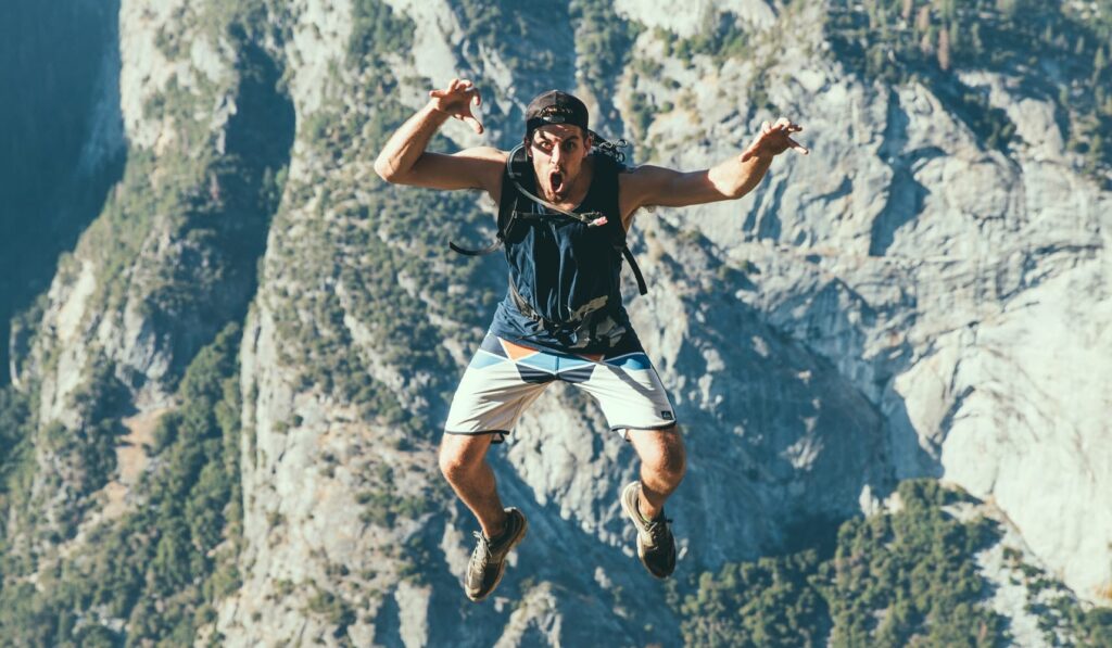 man jumping off mountain