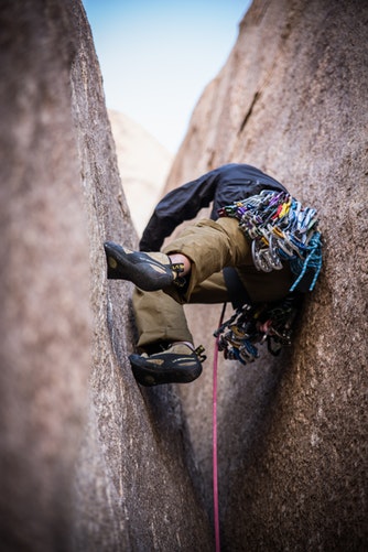 rock climber between narrow rock formation