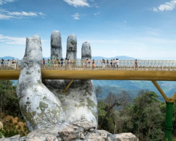 bridge being held by large hand