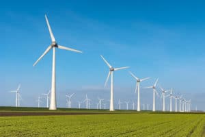 row of white windmills against blue sky